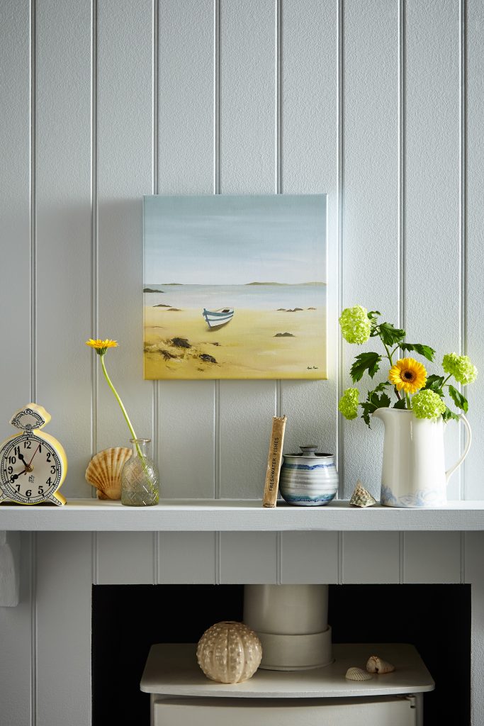 Beach scene wall art above a fire place by Laura Ashley