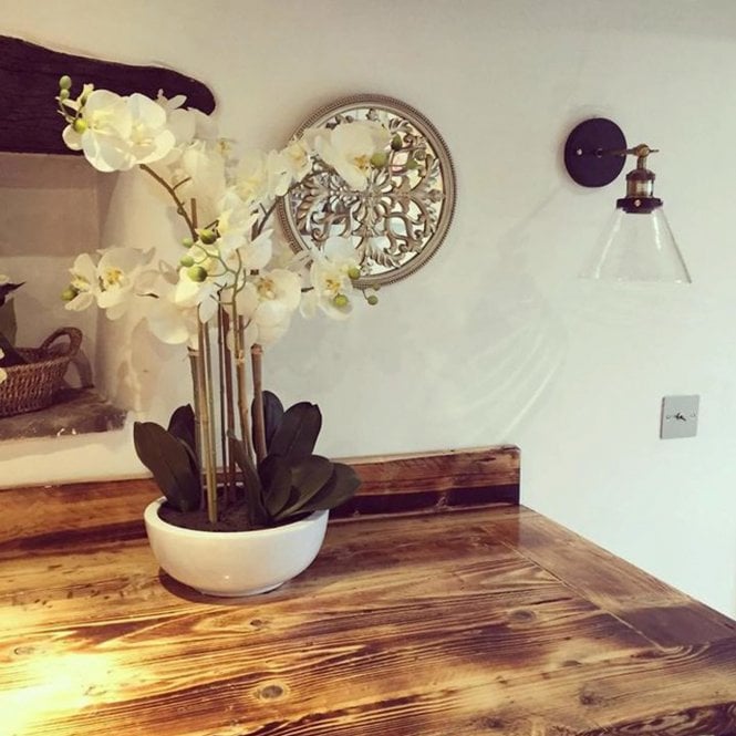 wall light next to a fireplace and kitchen table