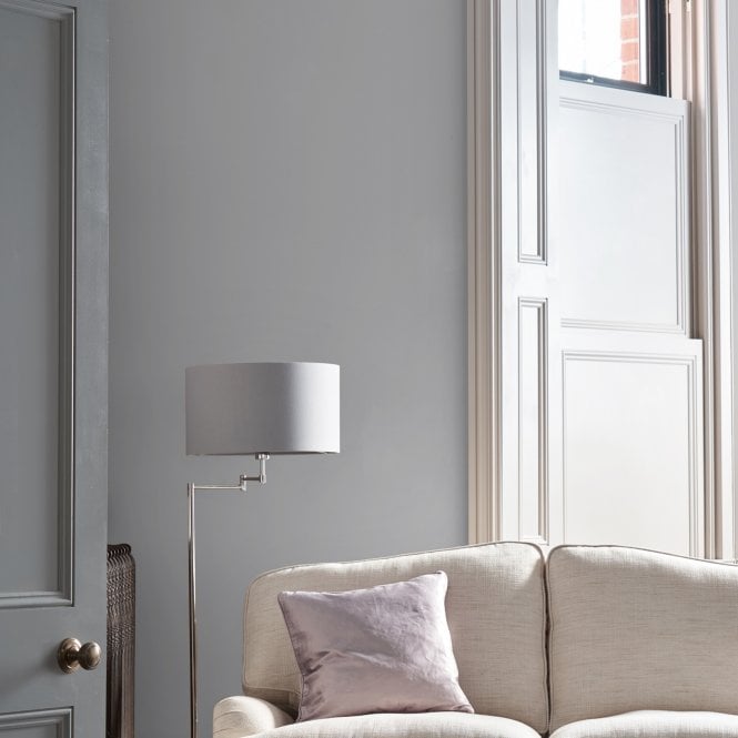 Living room walls in Laura Ashley grey paint colour with a floor lamp and cream sofa.