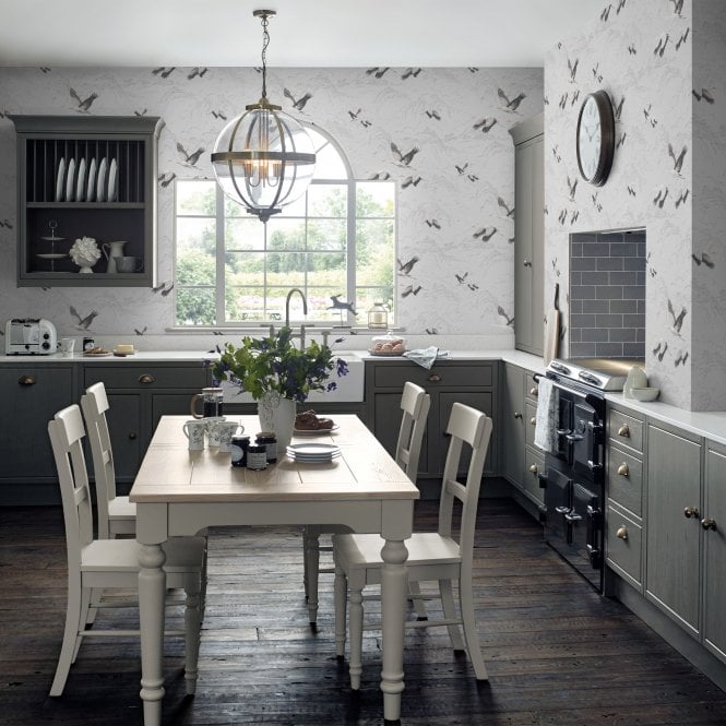 Country style Kitchen with Laura Ashley wallpaper and large ceiling pendant. 