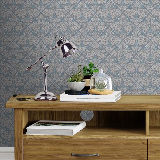 A Sideboard in front of Laura Ashley wallpaper with table lamp and home accessories