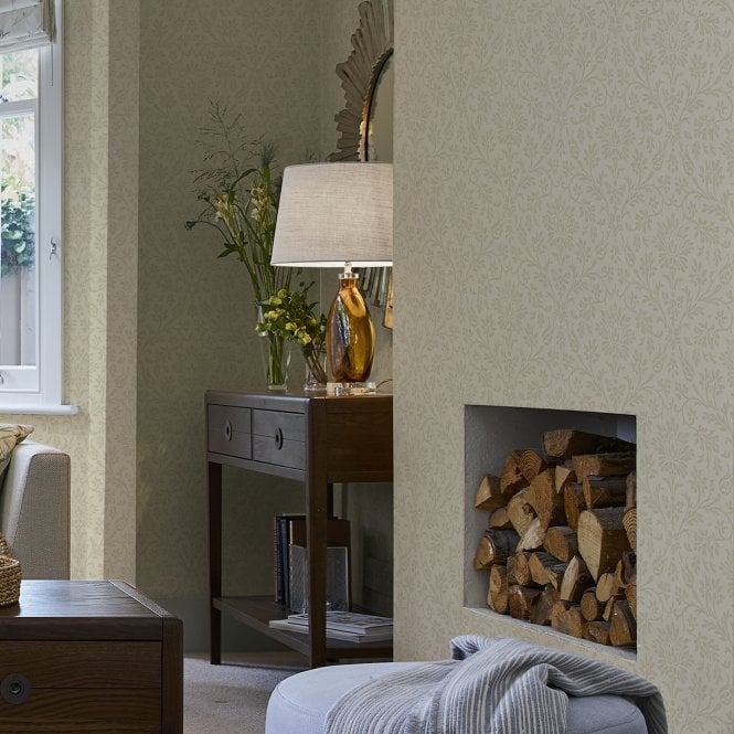 Laura Ashley wallpaper in a front room around a fire with home accessories.