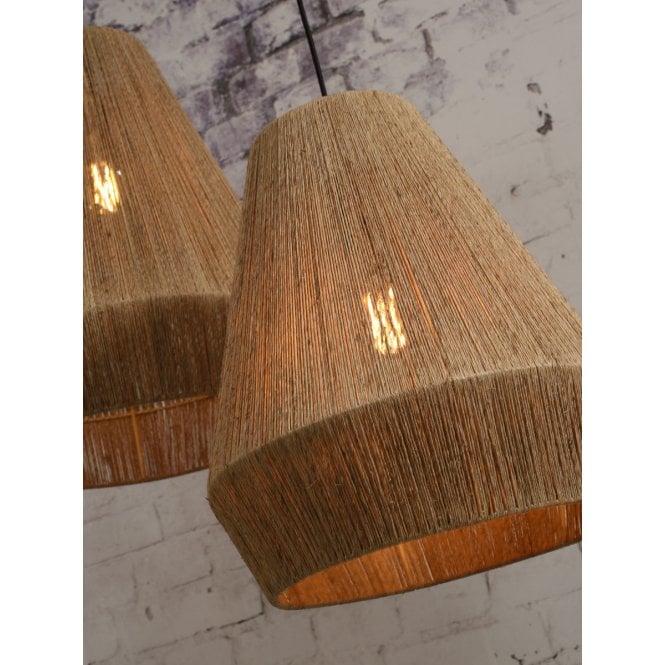 A close up of two ceiling pendant lights against a white bricked wall background.
