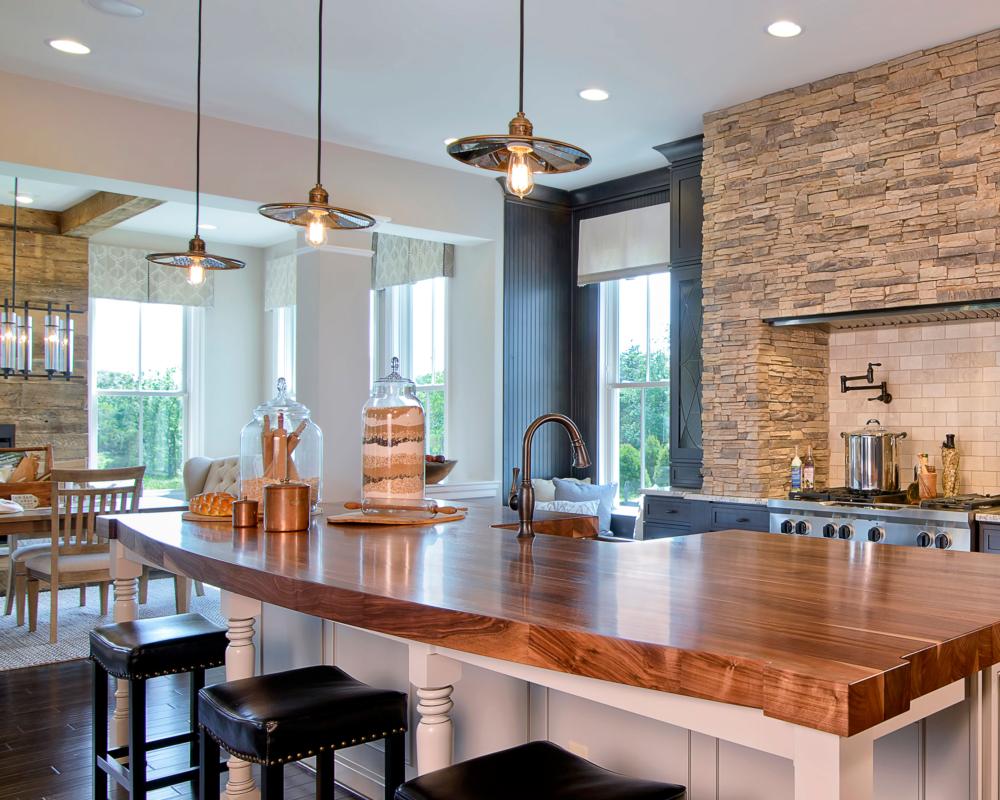 Open plan kitchen and dining area with three ceiling pendants
