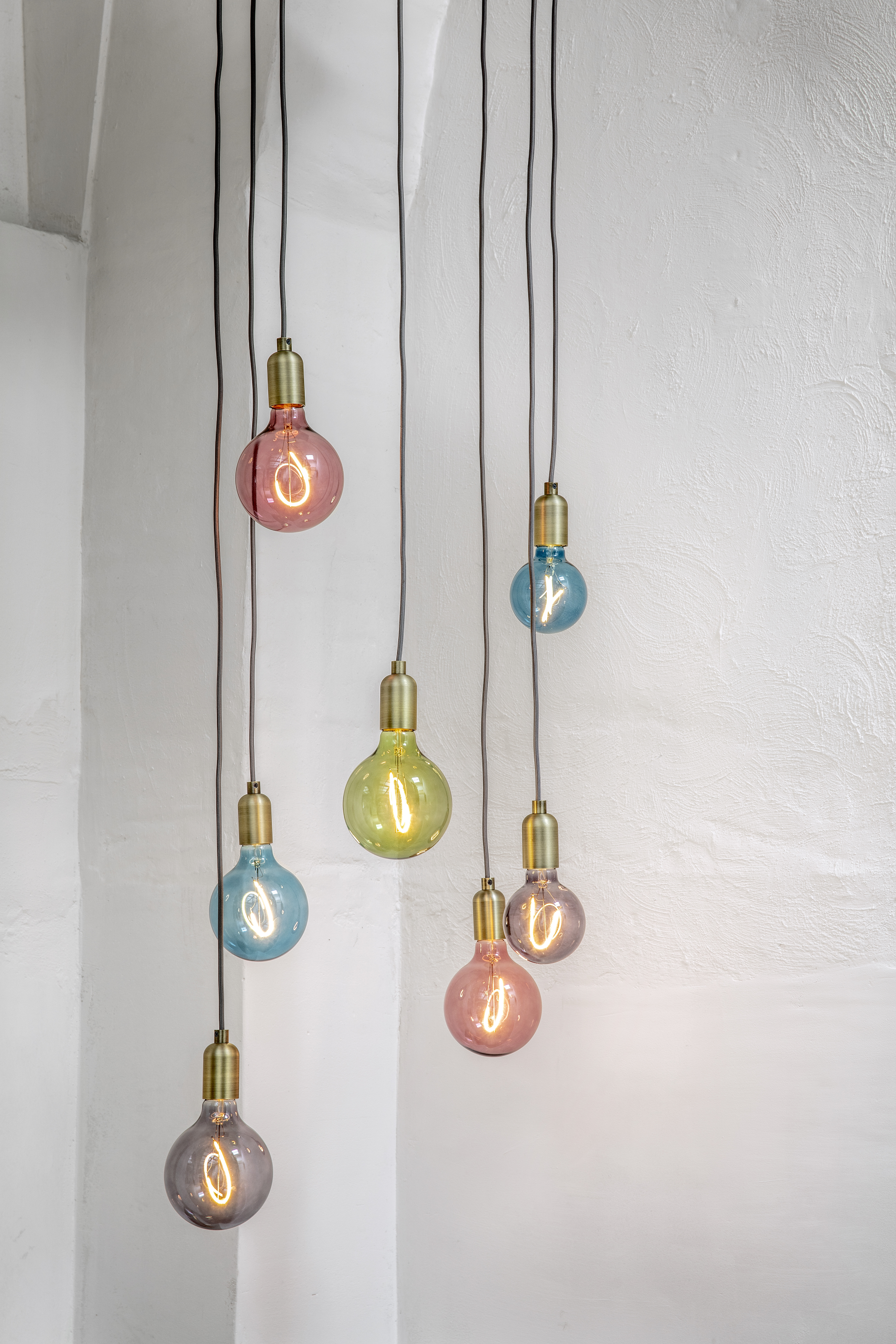 A cluster of decorative and oversized bulbs hanging on cords.