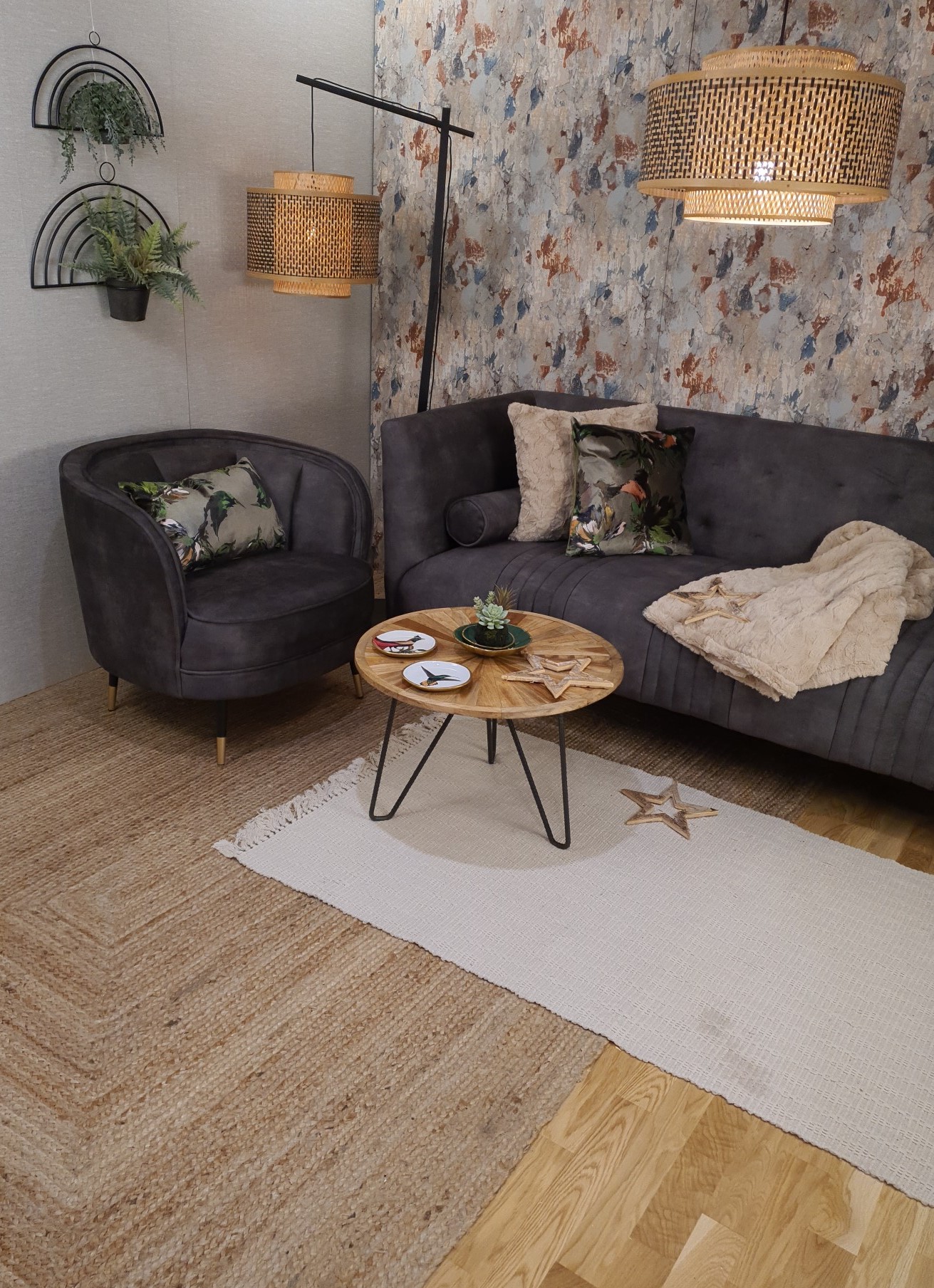Living room setting with a sofa, chair, coffee table and rug. A pendant light hangs over the sofa.