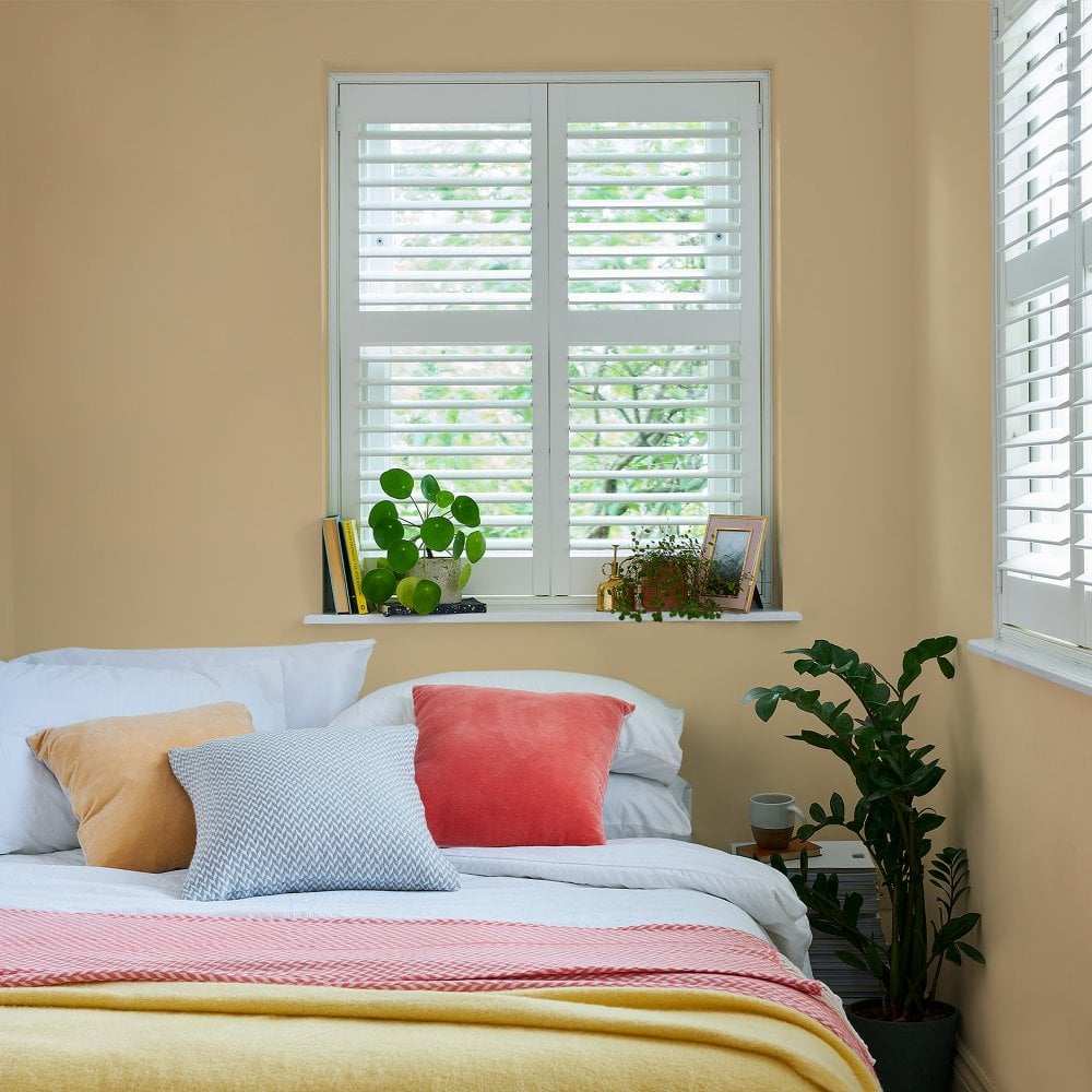 A bedroom setting with golden walls.