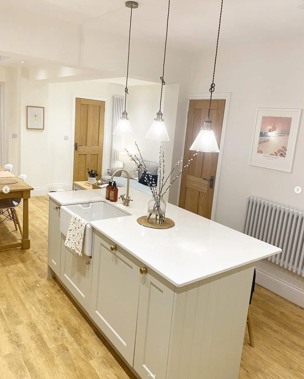 Open plan kitchen with three pendant lights