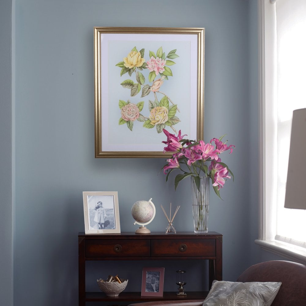 Laura Ashley wall hanging behind living room furniture.