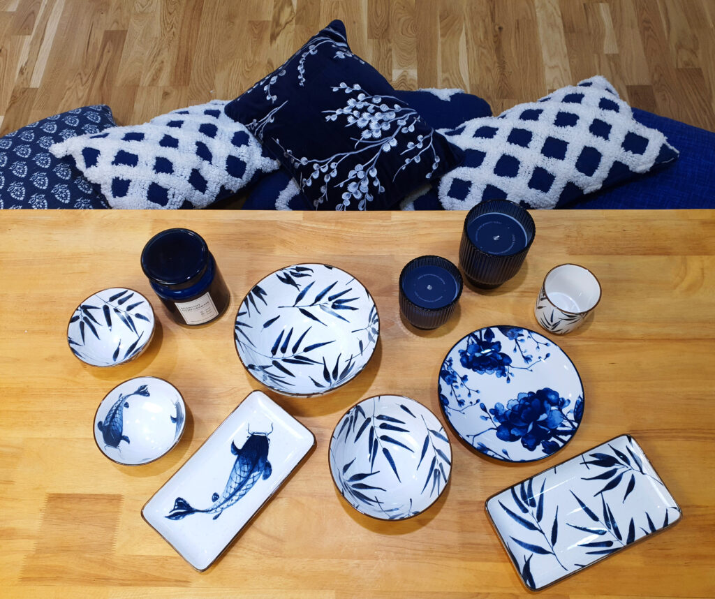 Blue and white plates, bowls and candles