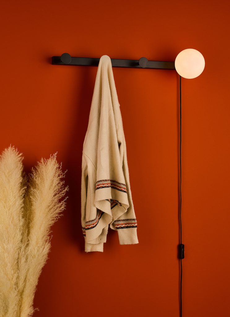 Plug in wall light with coat hooks