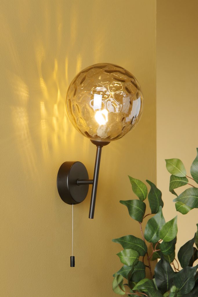 black wall light with smoked dimpled glass globe shade
