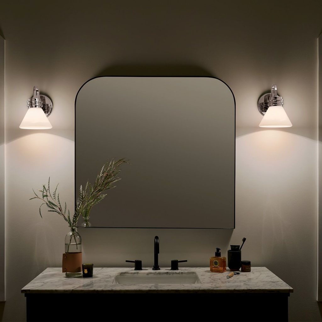 Beautifully styled bathroom vanity lights either side create an inviting space. 