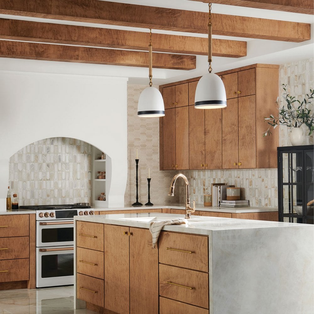 2 pendant lights above a kitchen island suspended on rope a nautical detail give an inspired coastal feel.