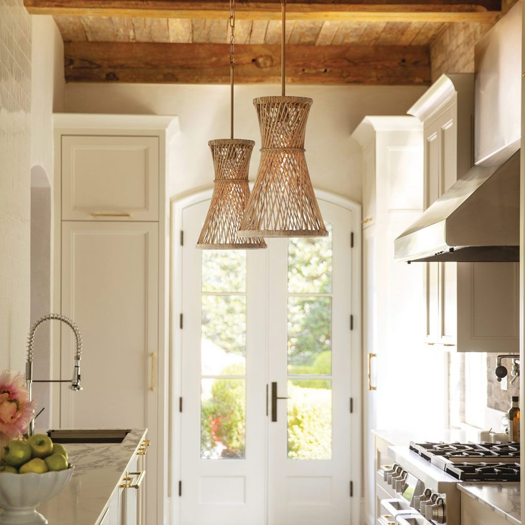 natural rattan light fittings in a wood and cream Kitchen that has a light and airy coastal inspired theme