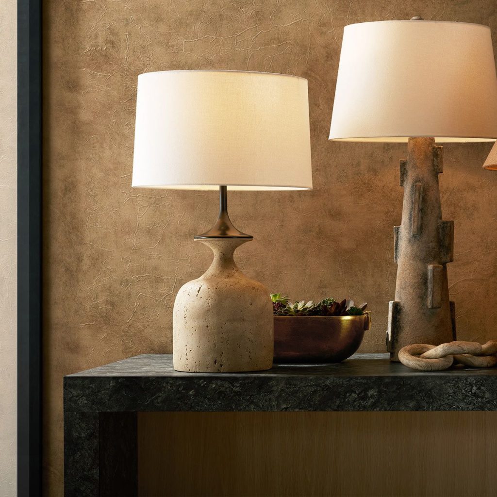 two table lamps with a natural stone base and cream lampshade on a side table giving a warm and homely glow
