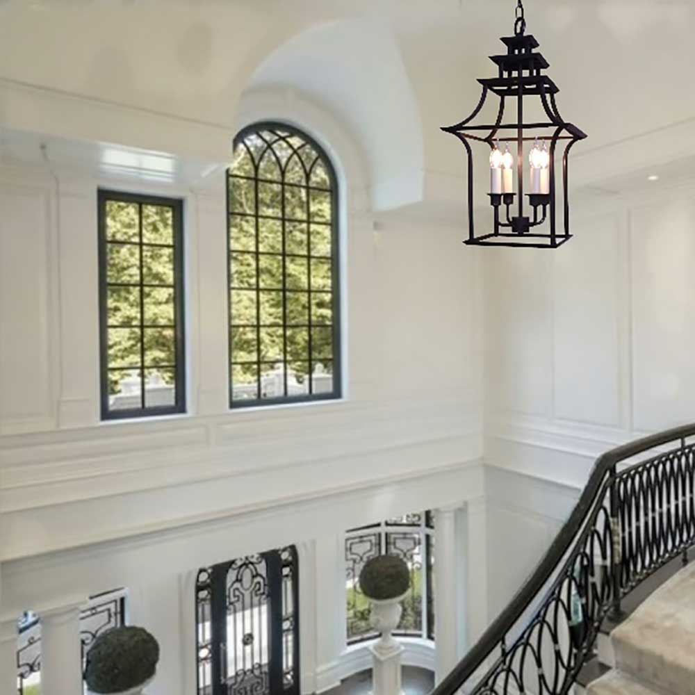 A large gothic inppired lantern hanging in a high ceiling hallway of a period property