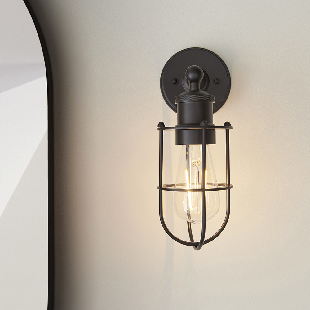 A black wall mounted light fitting in a modern gothic style with warm LED bulbs