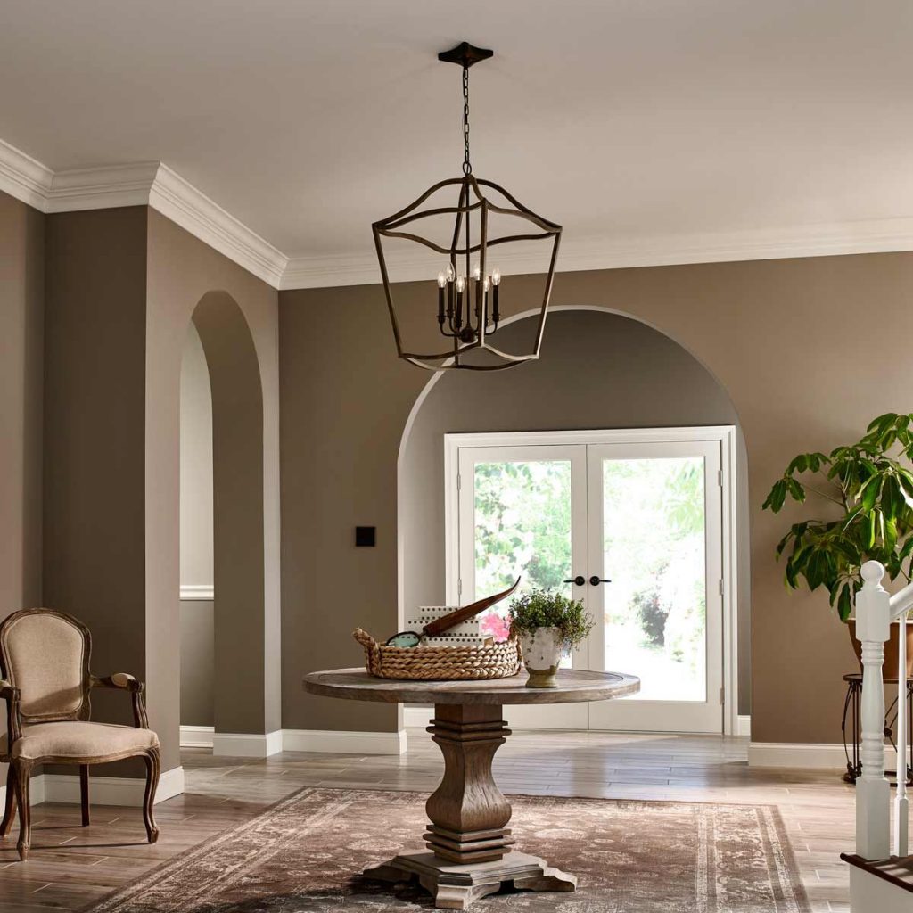 A modern metal hanging lantern that is inspired by the medieval style of interior design, hanging in a period home