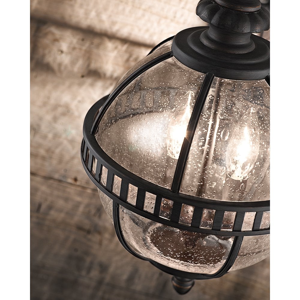 a wrought iron and glass bathroom light with candle style bulb