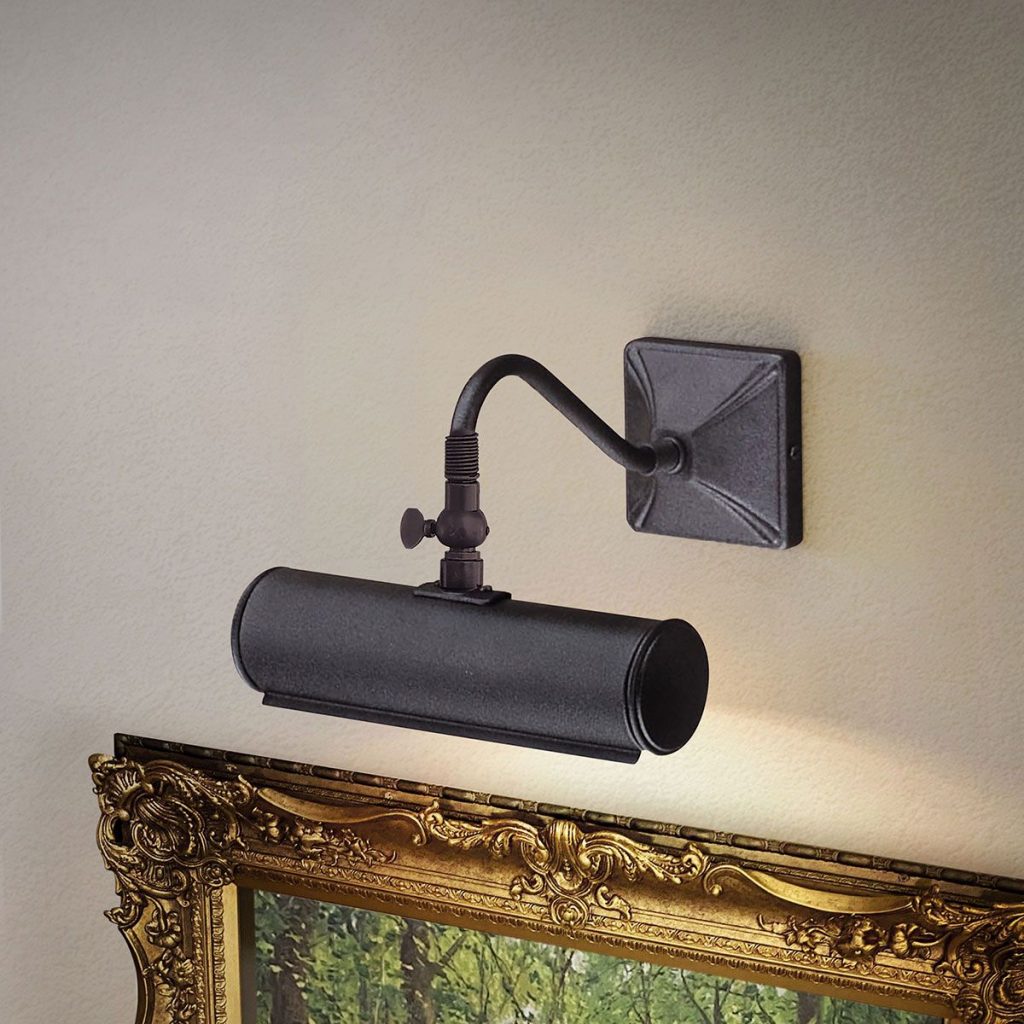 A black picture light above an old fashioned style painting in a period home