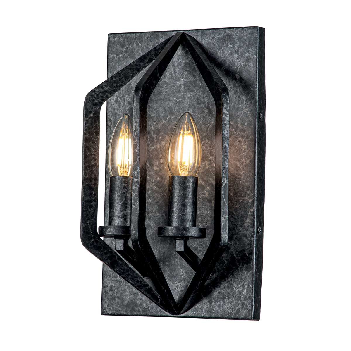 A wrought iron style wall light fitting with warm candle style bulbs suited to a medieval style period home