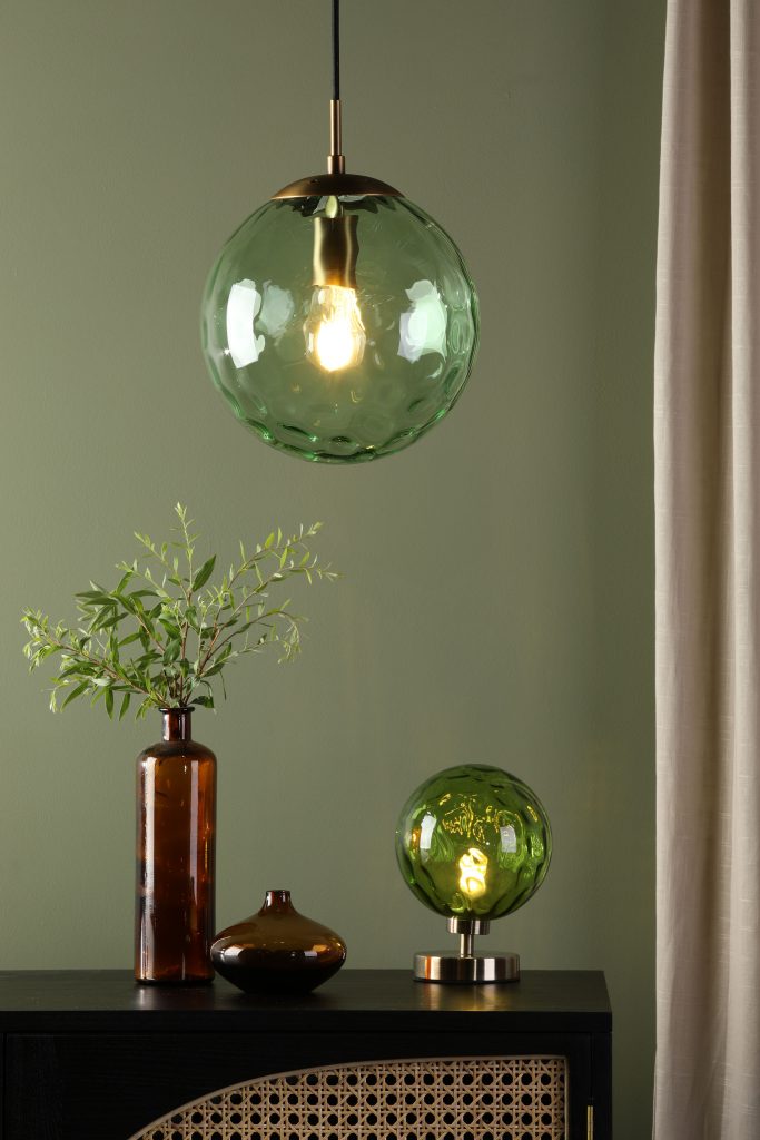 a green textured glass globe pendant with matching globe table lamp