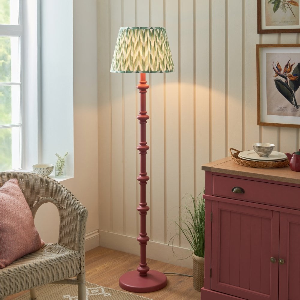 a pink floor lamp base with green fabric zigzag patterned light shade