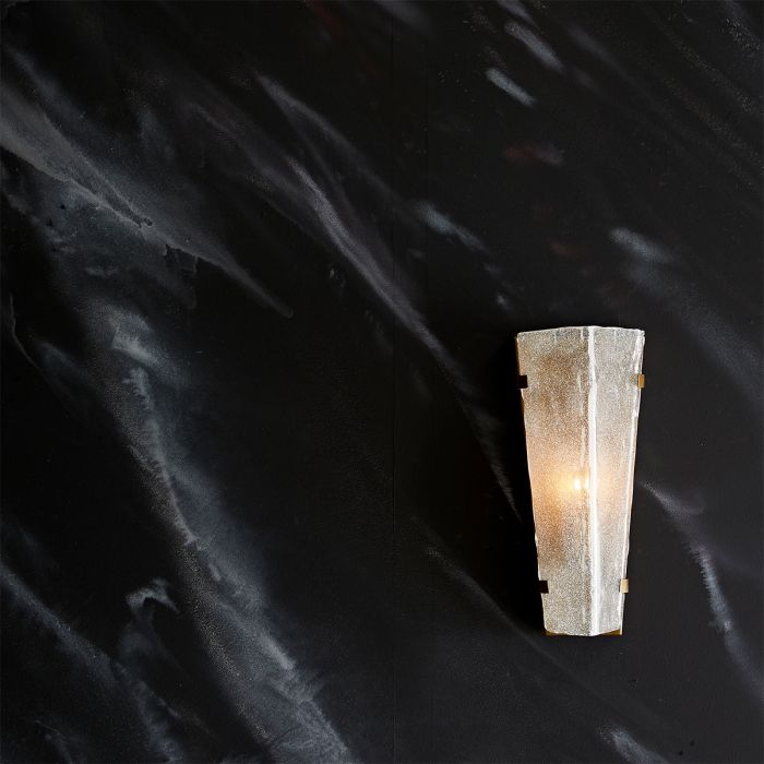 a modern stone effect LED scone on a marble wall