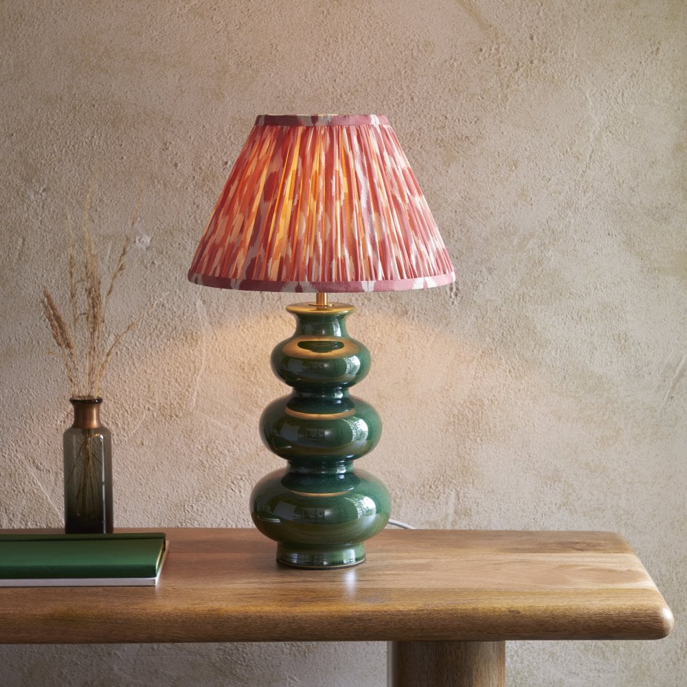 a ribbed design ceramic lamp base in green with a pink patterned fabric shade