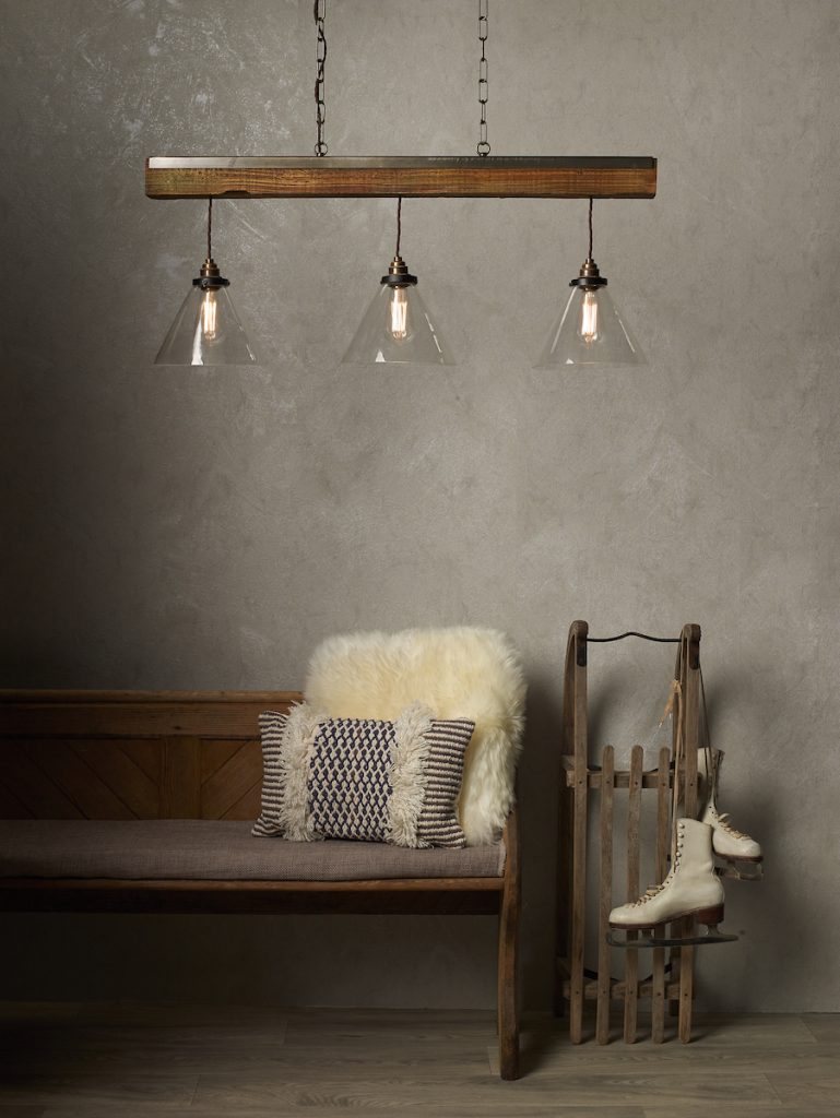 a rustic pendant bar light with aged brass and glass shades