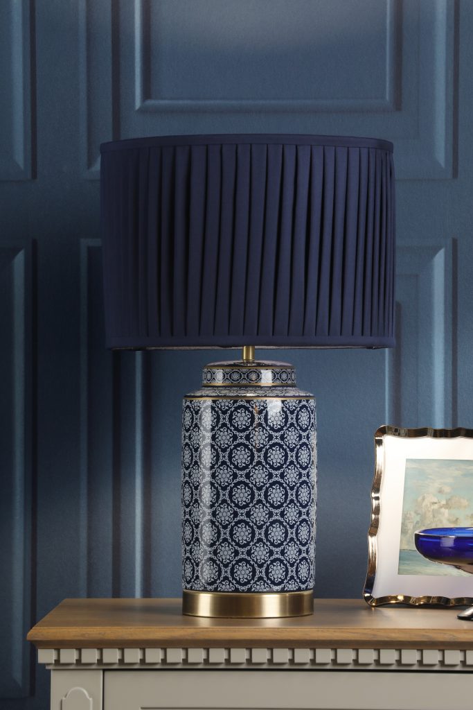 a statement table lamp in navy blue and brass