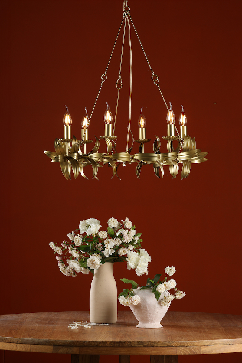 a large decorate aged brass round chandelier suspended above a table perfectly suited to modern and traditional, period interiors