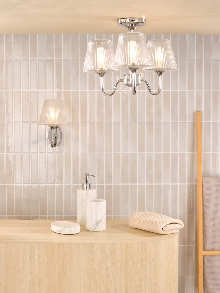 matching polished chrome and ribbed glass wall light and three arm semi flush ceiling light in a bathroom