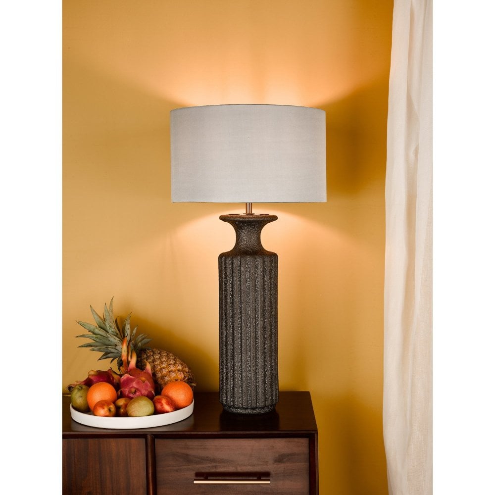 a large statement table lamp with stone base and white linen shade