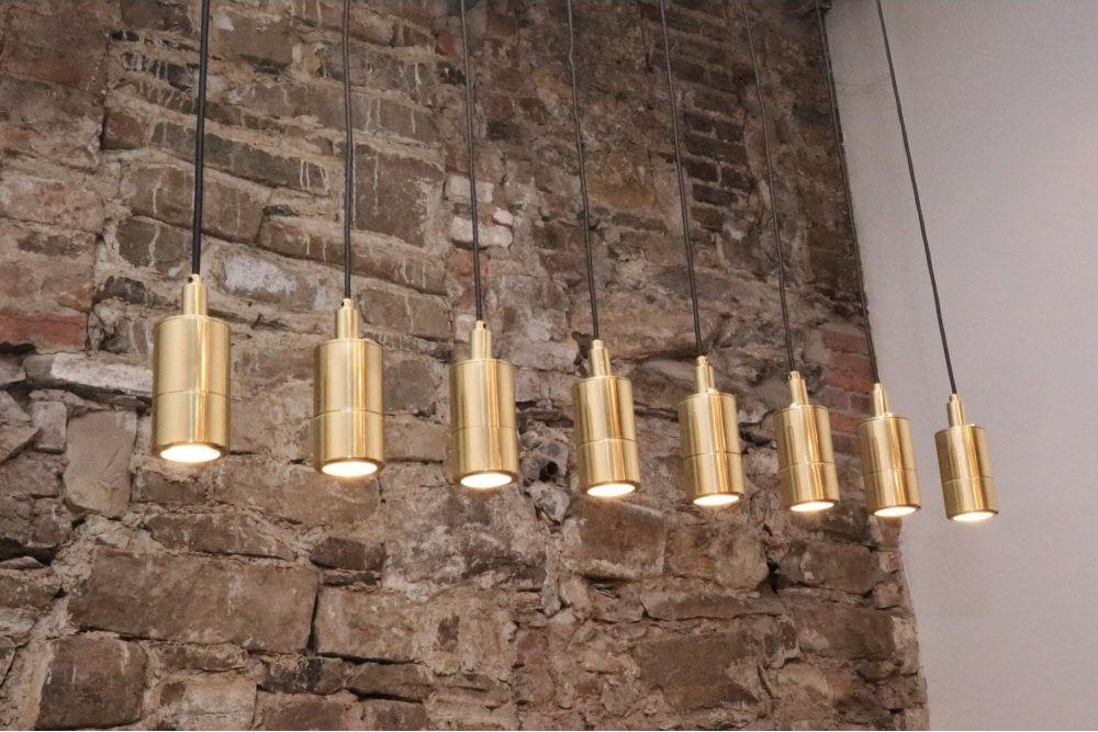 a line of modern gold tubular pendants