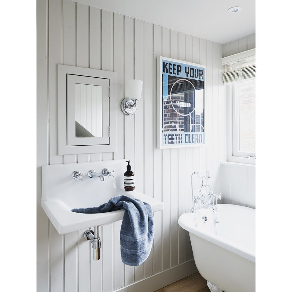 a white period style bathroom with white panelled walls and period style bathroom fixtures