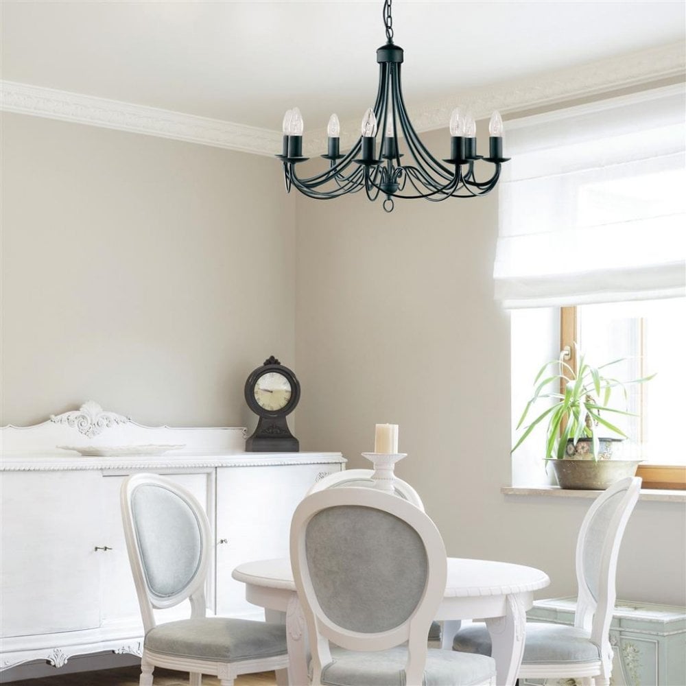 a hanging black chandelier with exposed candle bulbs