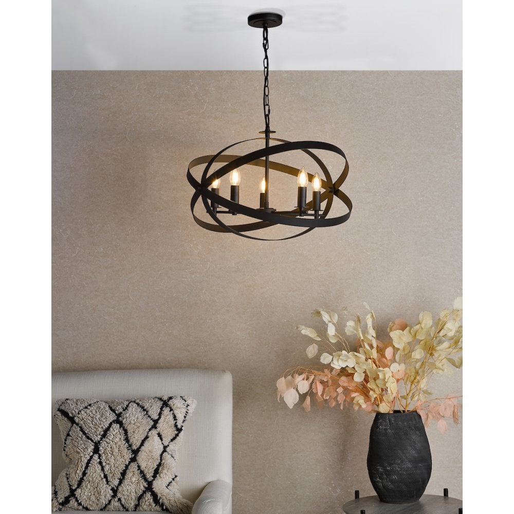 a modern black chandelier with exposed candle bulbs and decorative framework