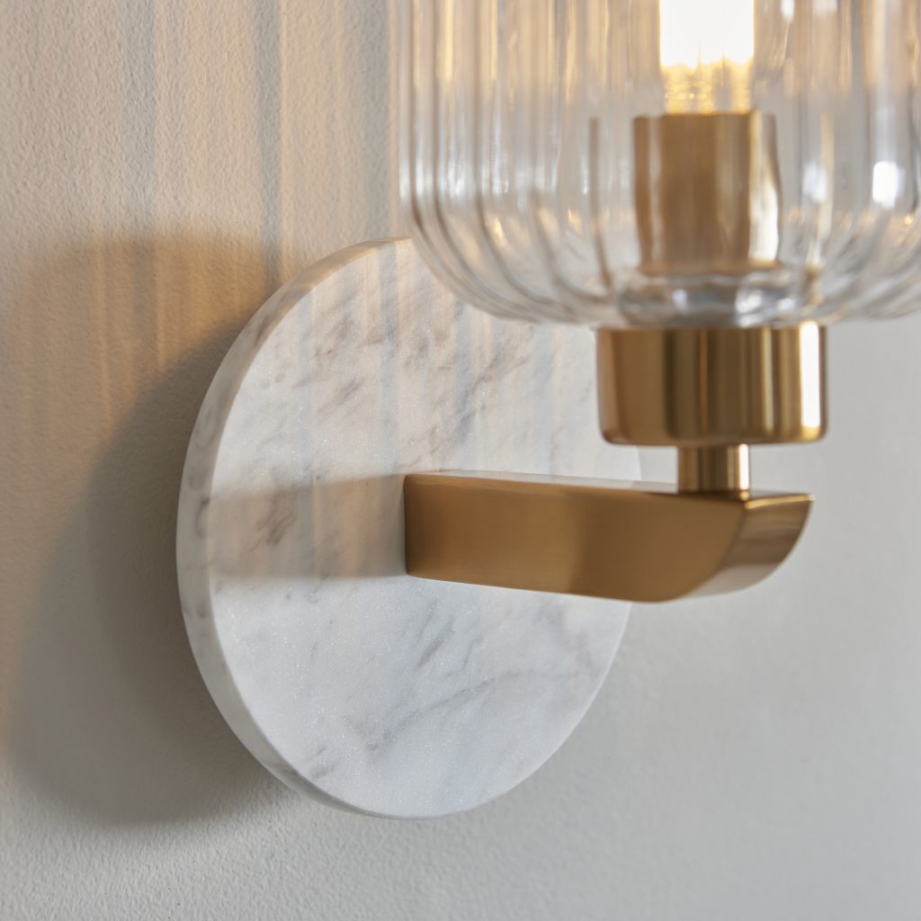 volaskas marble wall light with brass arm and ribbed glass shade