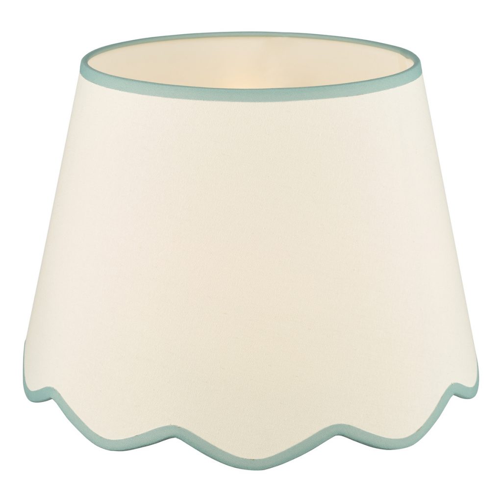 a neutral scalloped edge lampshade with blue trim which is on trend