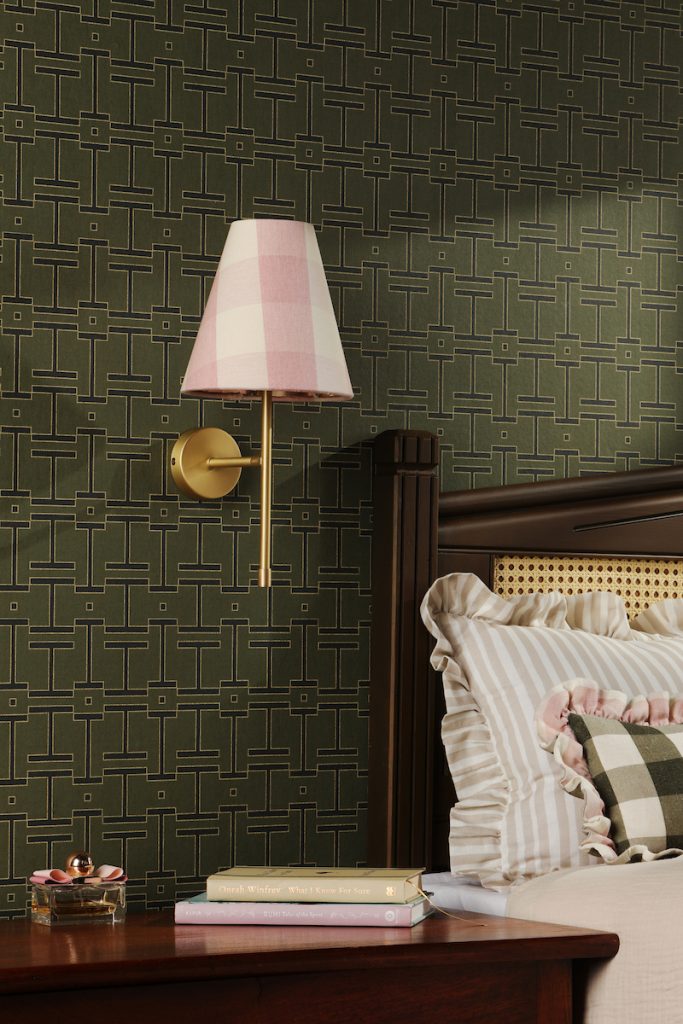 a modern brass wall light with lampshade