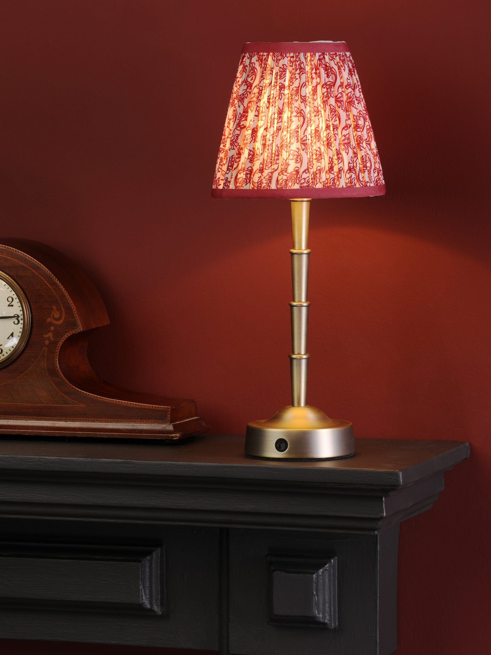 brass lamp base with red patterned shade
