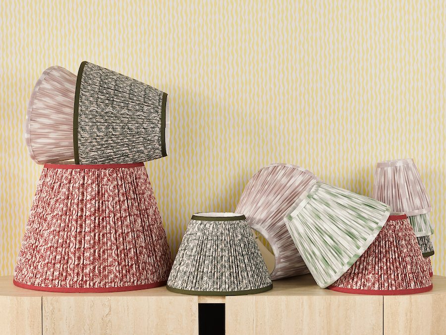 a stack of patterned lamp shades in different colours and sizes