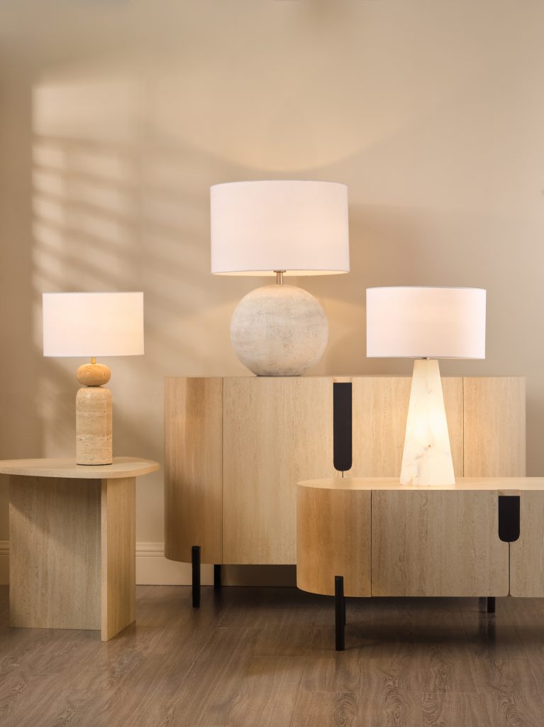 a trio of natural stone table lamps on stone and alabaster with neutral shades