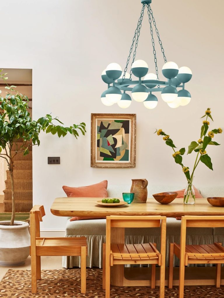 Large blue ceiling light above table.
