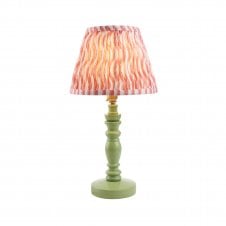 green wooden table lamp with pink ripple pattern shade
