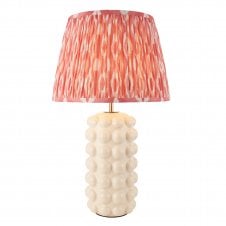 white ceramic table lamp base with pink ikat patterned shade