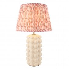white ceramic table lamp with pink ripple patterned shade