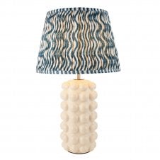 white ceramic table lamp with blue ripple pattern shade